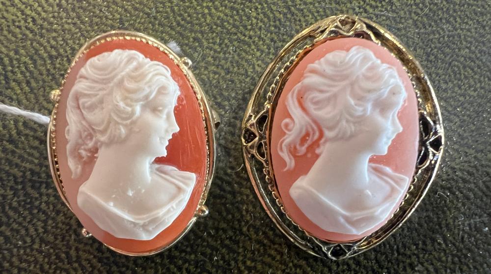 Two shell-style cameo brooches depicting classical female profiles in gilt-metal mounts. Mid-20th century.