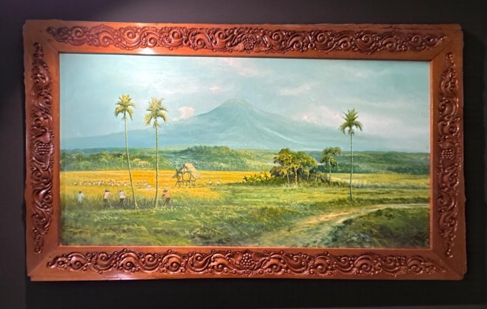 Javanese landscape painting, oil on canvas, in carved teak frame, unsigned, circa 1970s