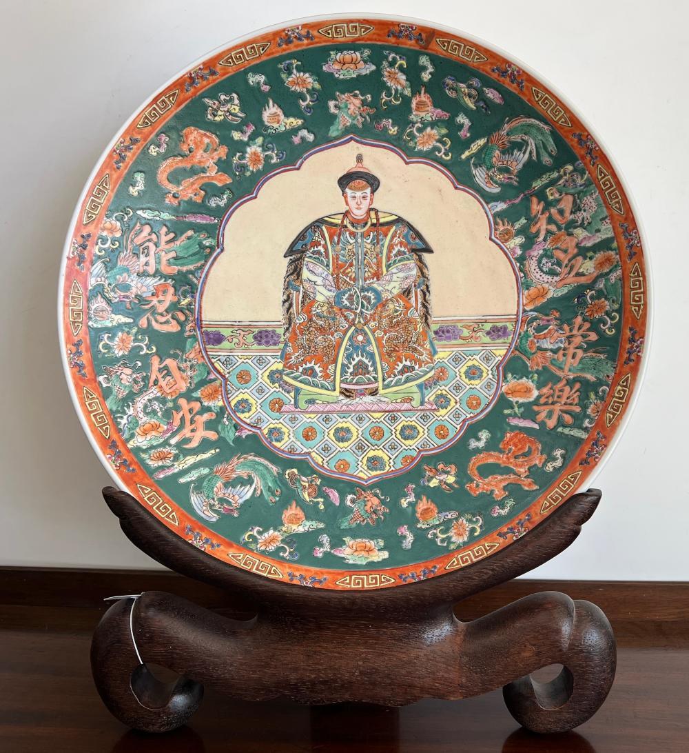Chinese famille rose charger on carved hardwood stand, presented in Hong Kong, circa 1970s