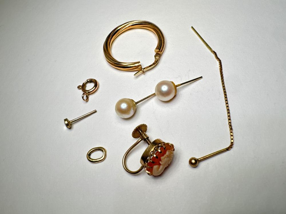Collection of yellow gold jewellery, including cultured pearl stud earrings, shell cameo earring, hoop earrings, and gold fittings, 20th century