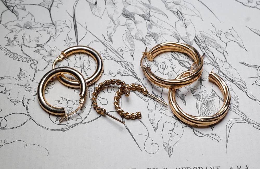 Collection of three pairs of gold hoop earrings, including twisted rope design, 20th century