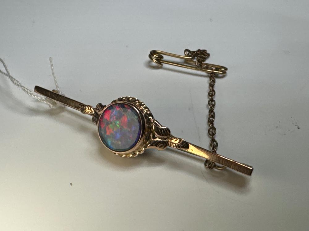 Australian 9ct rose gold bar brooch, black opal doublet and gumleaf mounts, c.1920