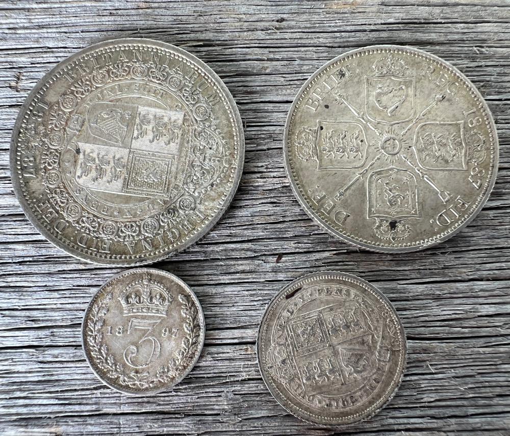 Group of four Victorian silver coins, comprising two 1897 crowns, an 1887 double florin and an 1897 threepence, late 19th century