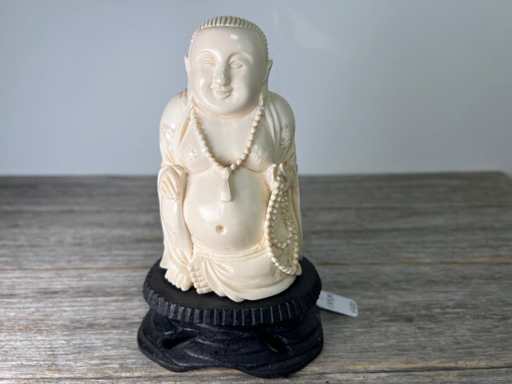 Carved ivory figure of Buddha on hardwood stand, earlier 20th century