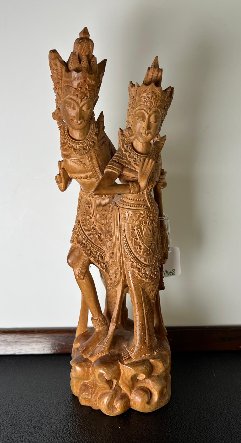 Balinese carved wood figure group of two deities in ceremonial dress and headdresses, circa 1960s–1970s