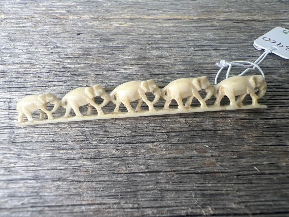 Carved ivory brooch, procession of five elephants on tapering base, early 20th century