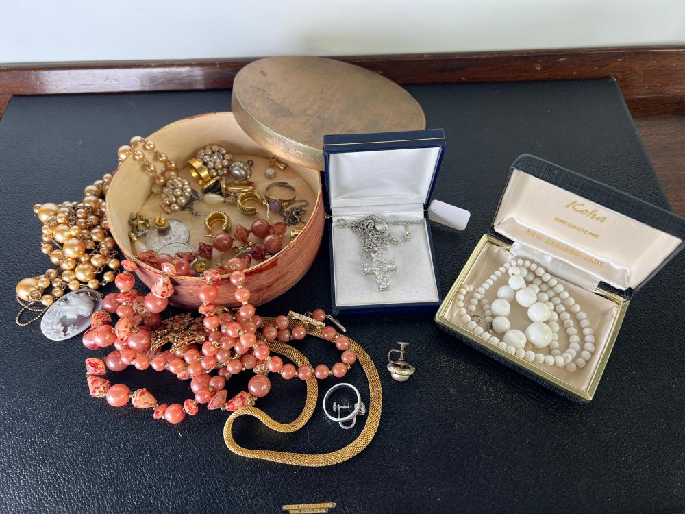 Collection of costume jewellery and trinkets, including New Zealand greenstone bead necklace, white metal filigree cross pendant, coral-tone bead necklaces and sundries, circa 1950s–1970s