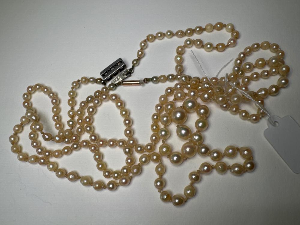 Two cultured pearl necklaces, one with 9ct gold clasp, one with silver clasp, 20th century